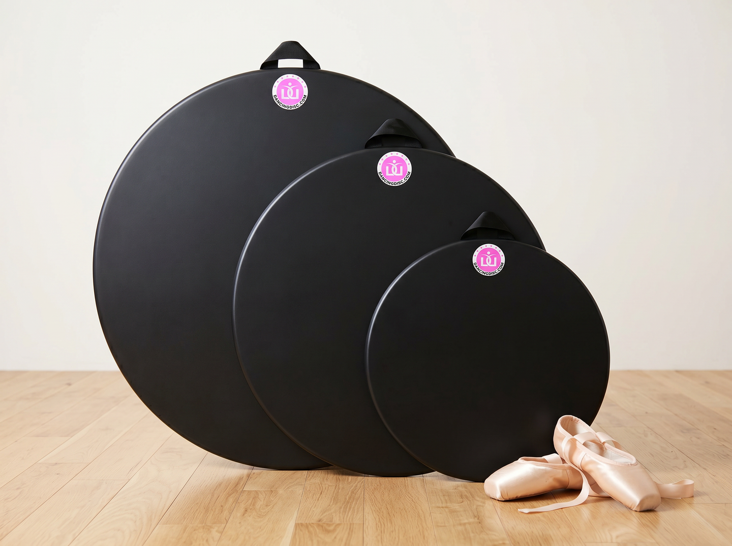 Dancing Disc in three sizes: 16-inch, 24-inch and 30-inch Marley turning boards, shown with ballet pointe shoes for scale