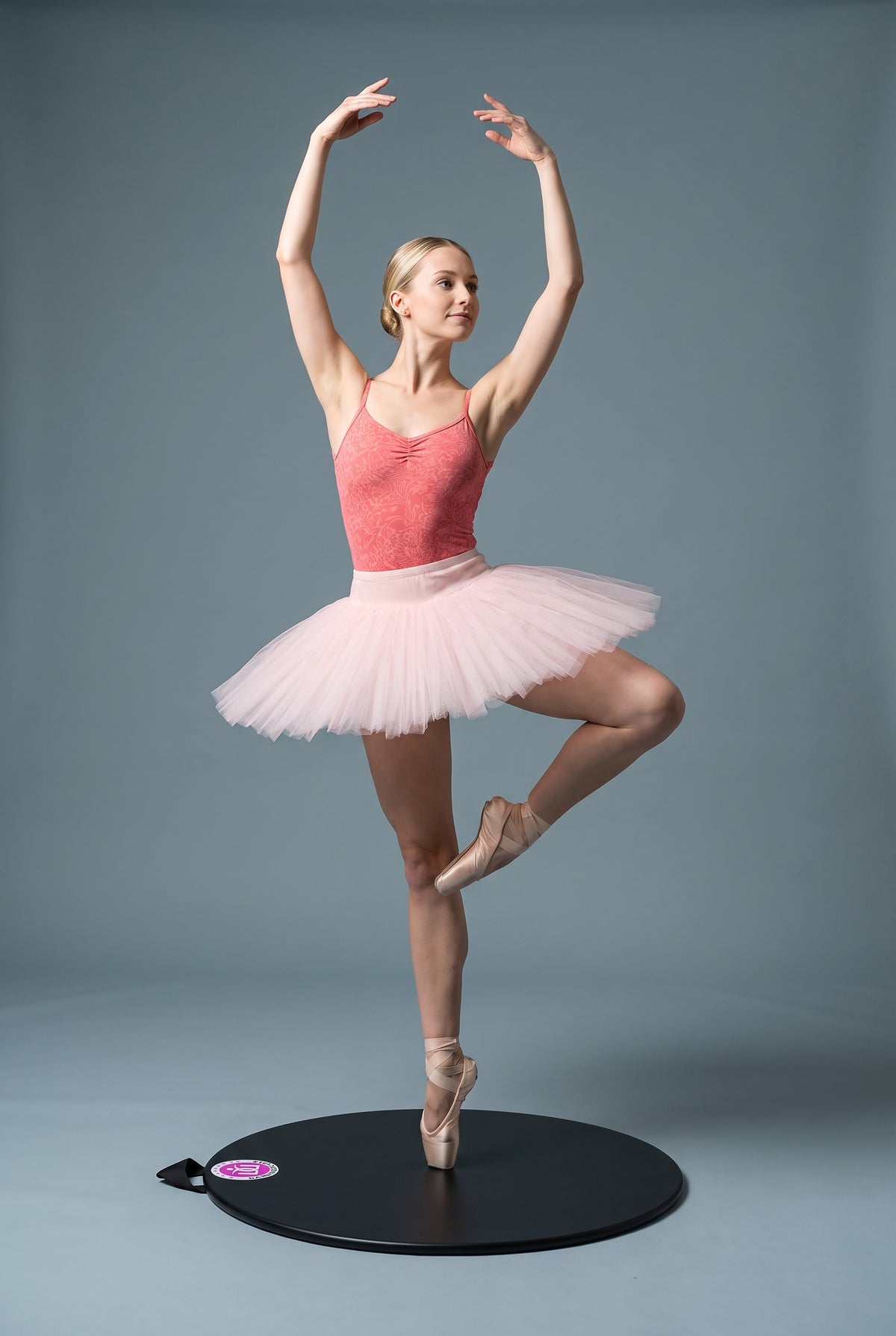 A young dancer in passé on pointe on her Dancing Disc